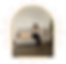 Woman on sofa working on laptop, framed by golden sunburst.
