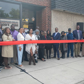 city of Detroit officials, owners and supporters of Heal Well Detroit posing to cut a ribbon