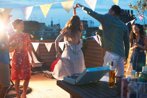 Group of guests dancing on rooftop