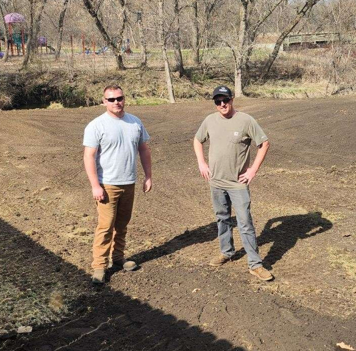 Dave and Ryan standing next to each other at a job site.