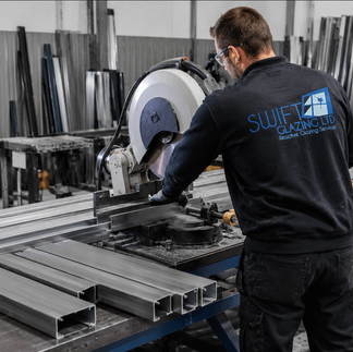 Steel profiles being measured and cut for a bespoke partition frame