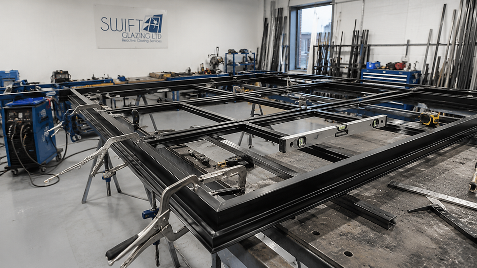 Bespoke black steel partition frame being fabricated and assembled in the Swift Glazing workshop before installation in London.