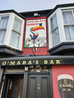 Outside O'Maras Bar with Guinness sign