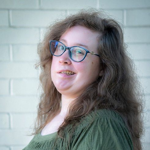 Smiling Woman with Wavy Blonde Hair and Glasses - Kerisa Shorthouse Portrait