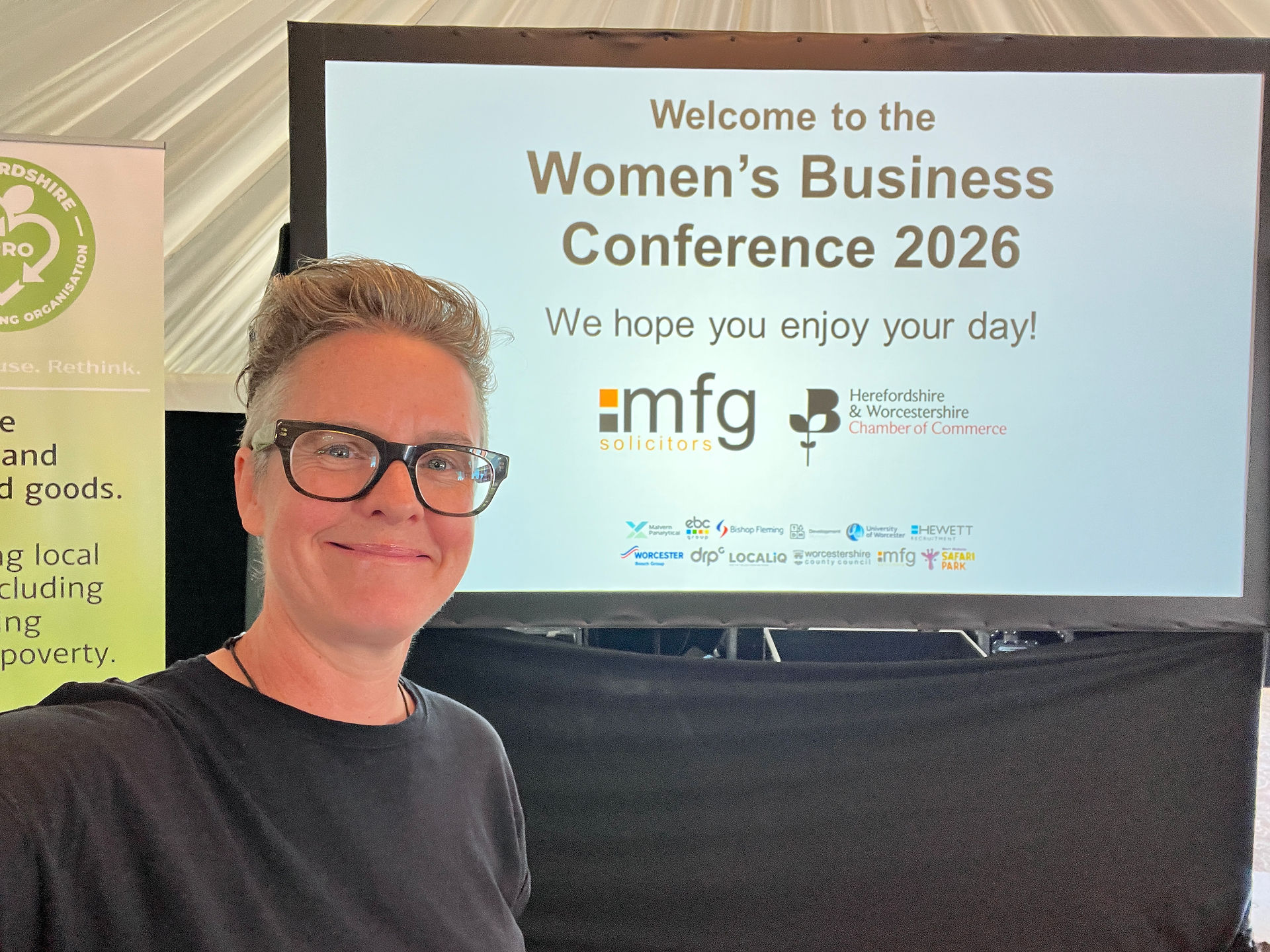 Jo in front of the Women's Business Conference 2026 screen