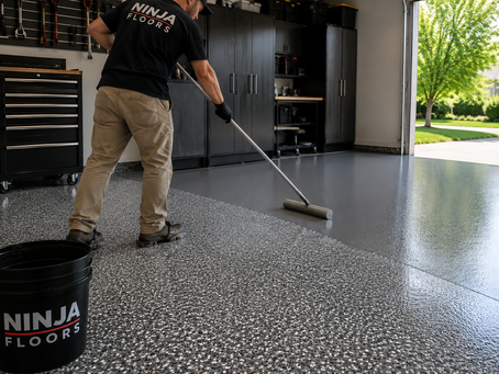 Ninja Floors technician applying epoxy coating in a modern Cincinnati garage
