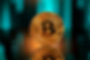 Bitcoin with reflection in front of a blurred blockchain background.jpg