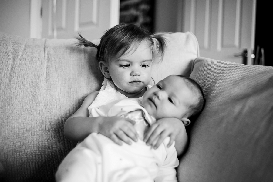 Little girl and baby sister - Family Photography Session at home in Dublin by Camila Lee Family Photographer 