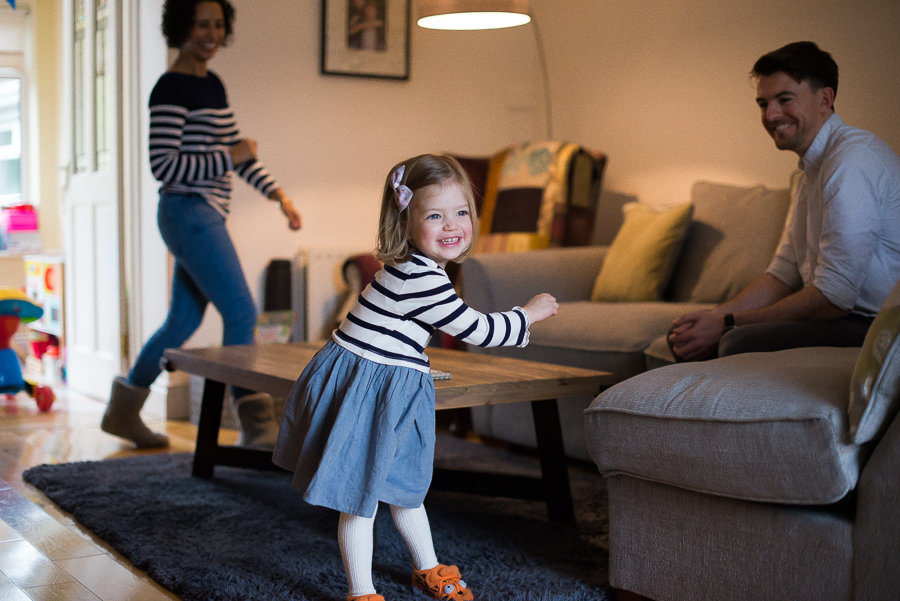 Family dancing at home in Dublin by photographer Camila Lee