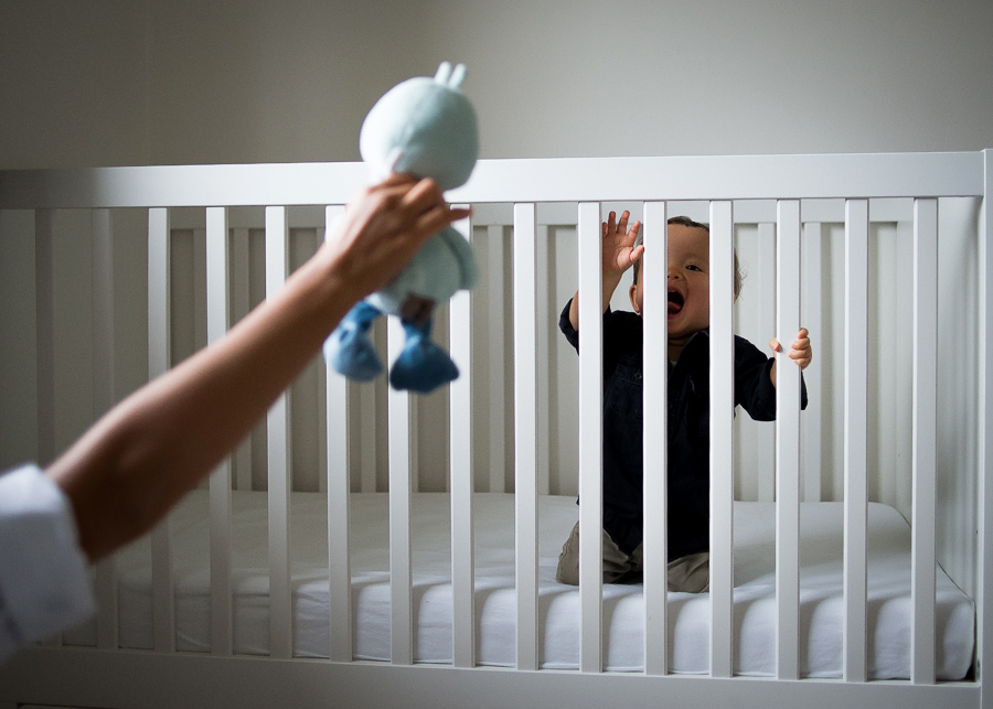 Baby in the cot - Family photography session at home in Dublin by Camila Lee