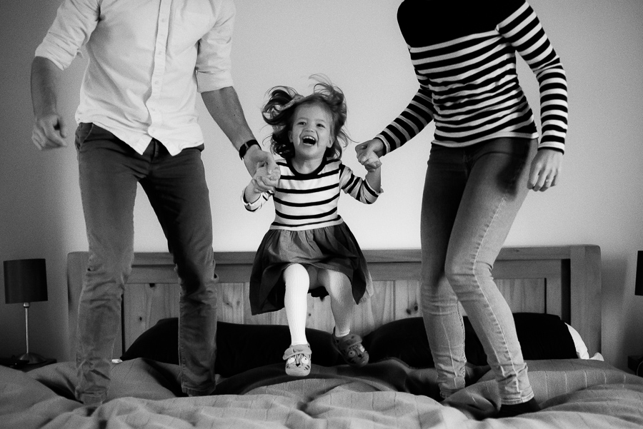 Family jumping on the bed - photoshoot at home in Dublin by Camila Lee
