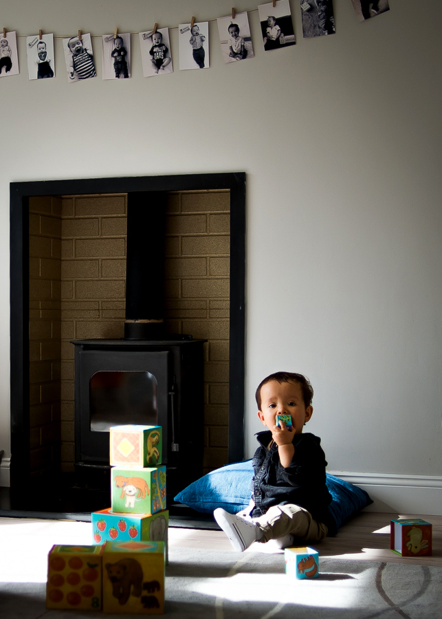 Baby oy playing with blocks - Family session at home in Dublin by Camila Lee