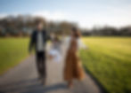 Family of mother, father and young daughter walking at a park