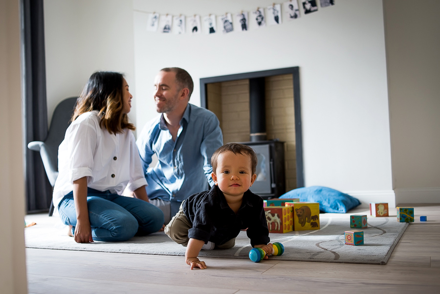 Mum, dad and baby in the living room - Family photography session at home in Dublin by Camila Lee