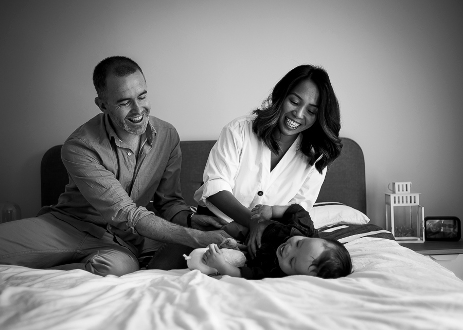 Mum and dad tickling baby - Family photography session at home in Dublin by Camila Lee