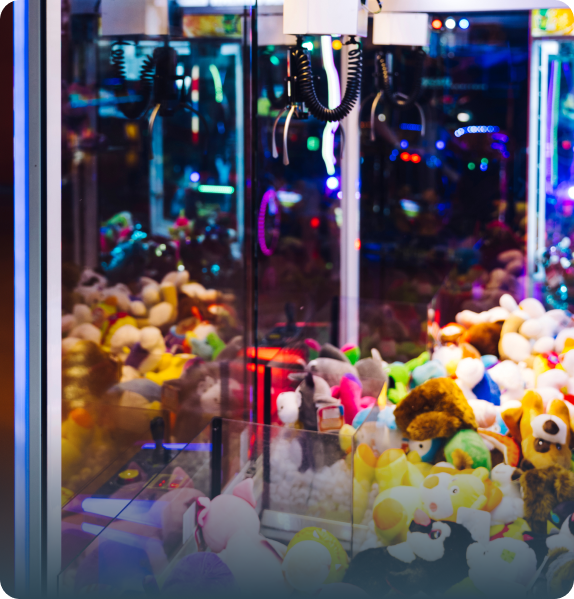 Gumball machine with colorful gumballs and a person inserting a coin