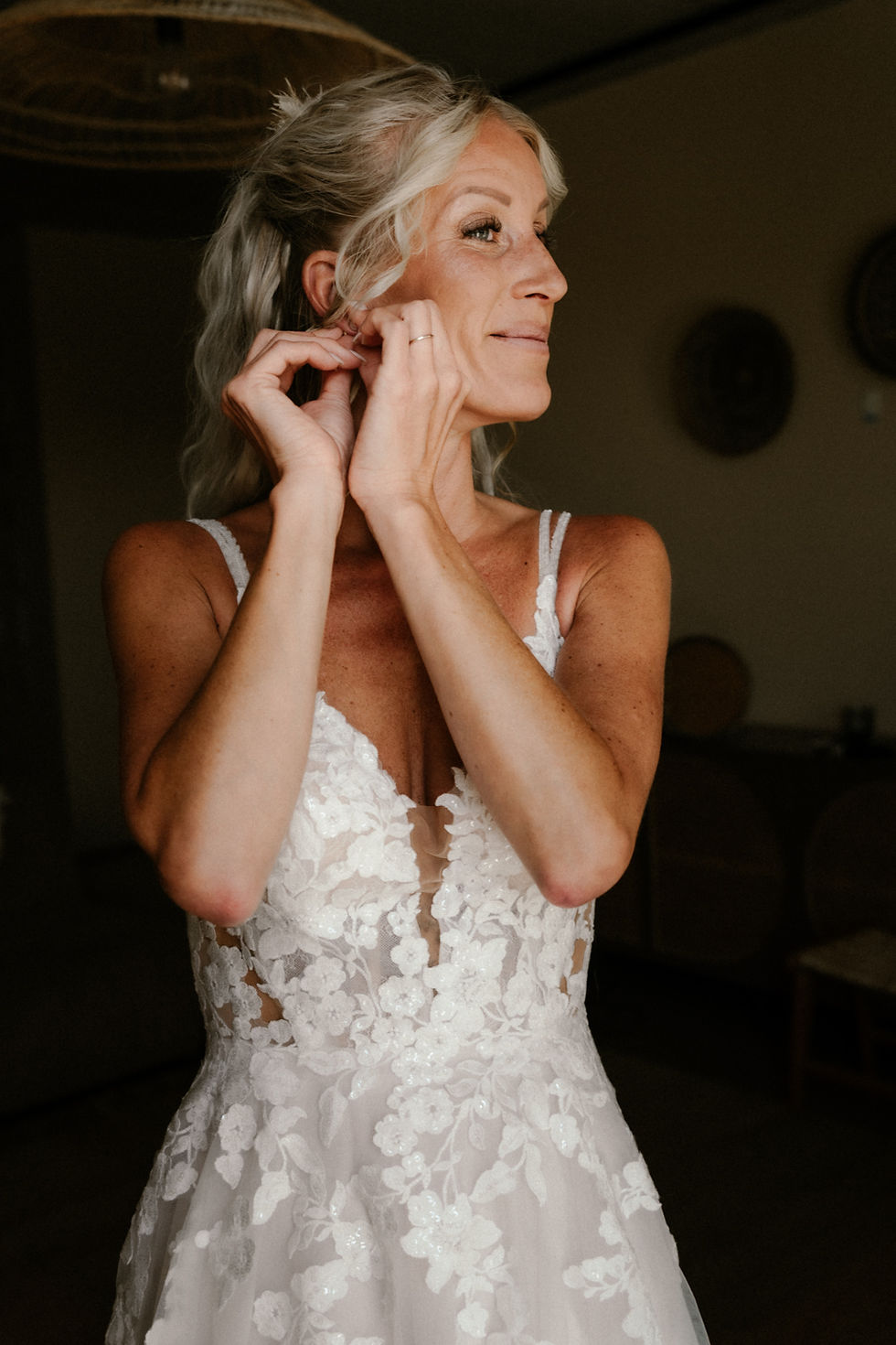 Bride puts on earrings