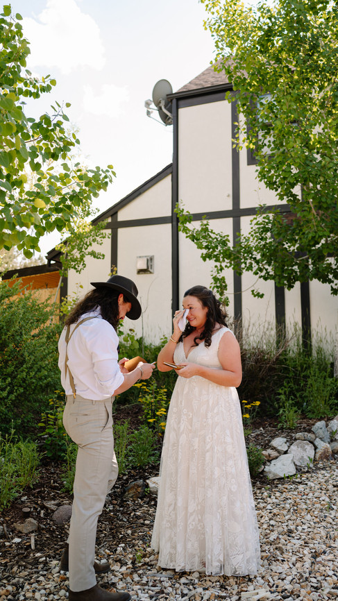 Matt and Keri reading private vows outside the onsite lodging at Blue Coyote Ranch near Salida, Colorado