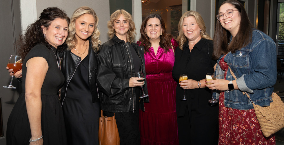Guests smiling at Feeding the Future fundraiser for CHOP Out Hunger