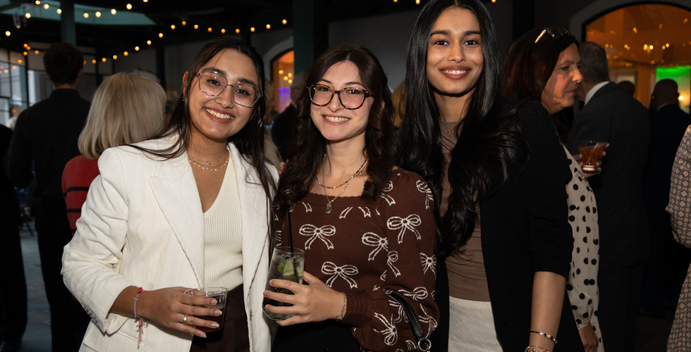 Guests smiling at Feeding the Future fundraiser for CHOP Out Hunger