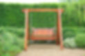 Wooden swing chair in natural green garden. Beautiful garden furniture..jpg