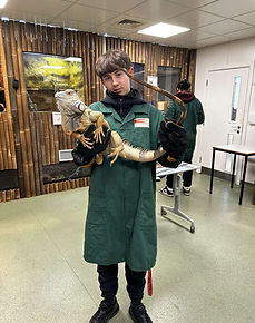 Influencer at animal sanctuary holding lizard