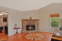 Stacked stone fireplace and hardwood floors at 1798 New Stock Road