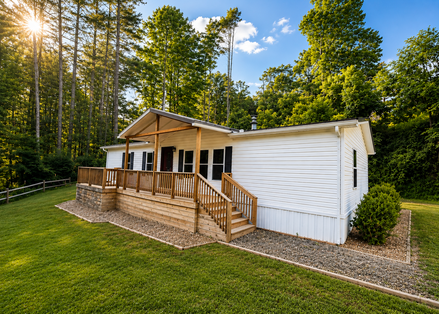 A modern mountain cabin exterior featuring large windows and surrounded by lush green trees.