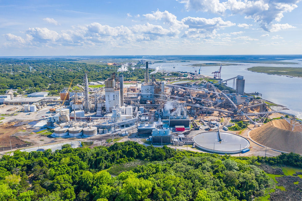 Aerial view of a pulp and paper mill beside a river