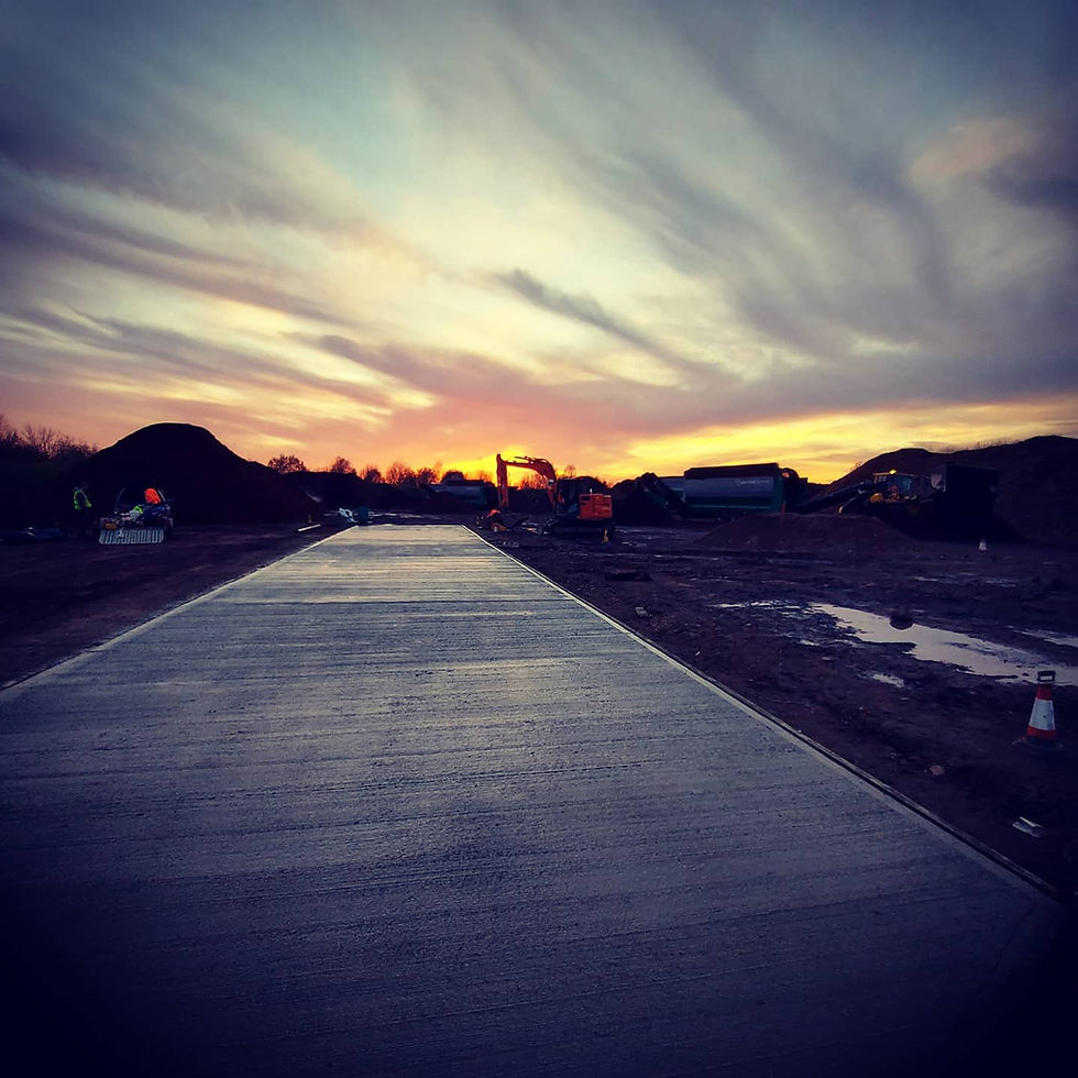 Sunset over freshly poured concrete road