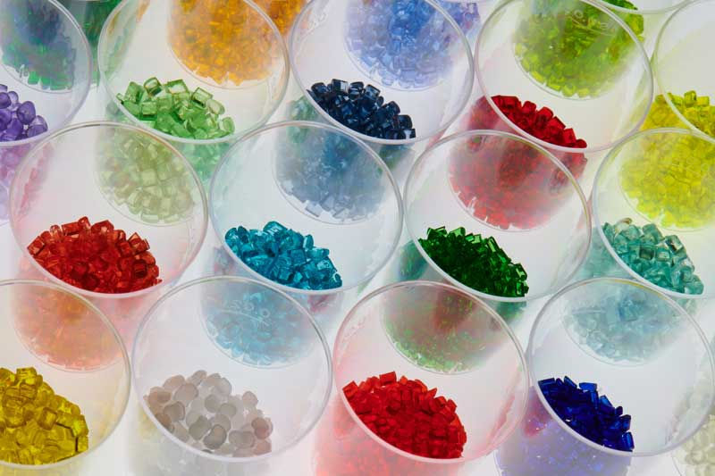 Various plastic pellets in a range of colours in petri dishes