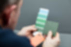Man holding product sample alongside colour swatch