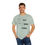Thumbnail: T-shirt with a line drawing odd a relaxed looking child stimming by listening to music, using a tangle fidget, and moving. The shirt has text that says "Let Kids Stim" | color: bay