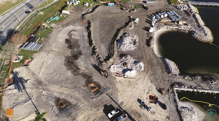 Aerial view of a construction site with earth moving activities in progress