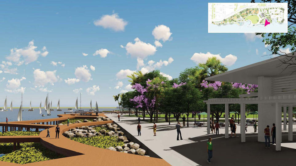 Scenic waterfront view with a pier, trees, people, and a blue sky above.