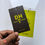 Thumbnail: Modern DH Casuals Corner hang tags in black and neon green with contact details printed.