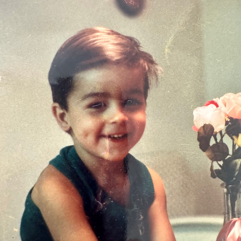 Matt sitting at the kitchen table at age two