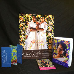 The print publication system for the exhibition placed on a table. A folded brochure standing uprigh