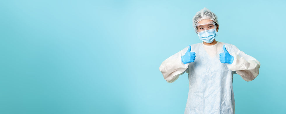 optimistic-asian-nurse-doctor-wearing-personal-protective-equipment-showing-thumbs-up-camp