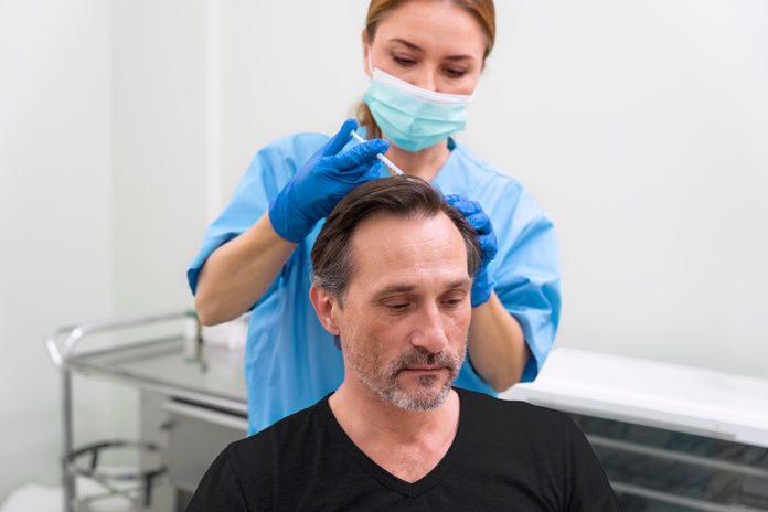 A man getting PRP treatment for hair loss.