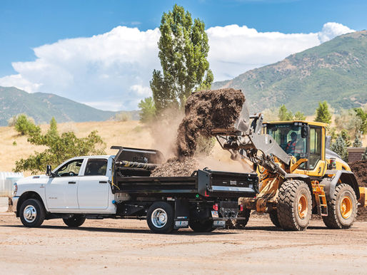 Dump truck getting filled with mulch to deliver to a city park