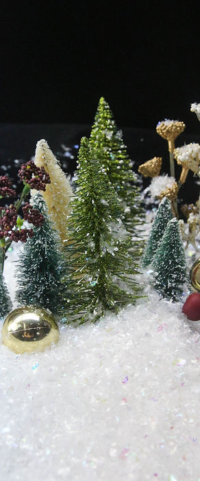Miniature model tree with irridscent artificial snow flakes fake snow