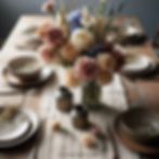 Use a low-profile flower bowl or clustered bud vases. Faux carnations or irises in muted colors work beautifully.