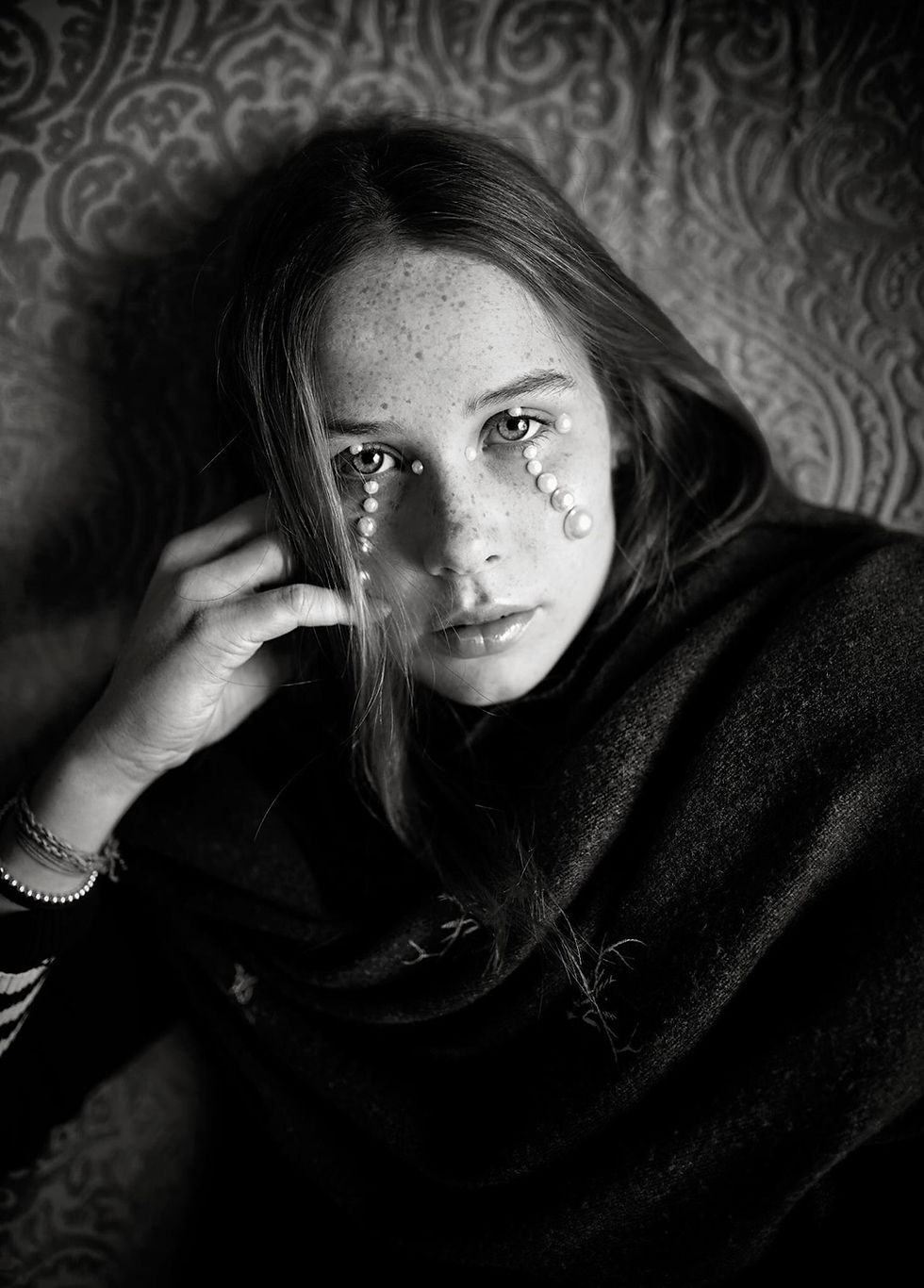 portrait of a beautiful young woman with pearls on her face