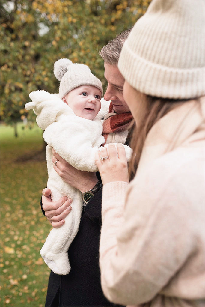 baby boy first smile with mum and dad, dublin park