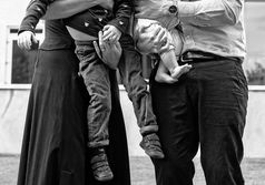close up of children's legs held by mum and dad