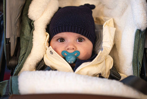 baby in pram with dummy