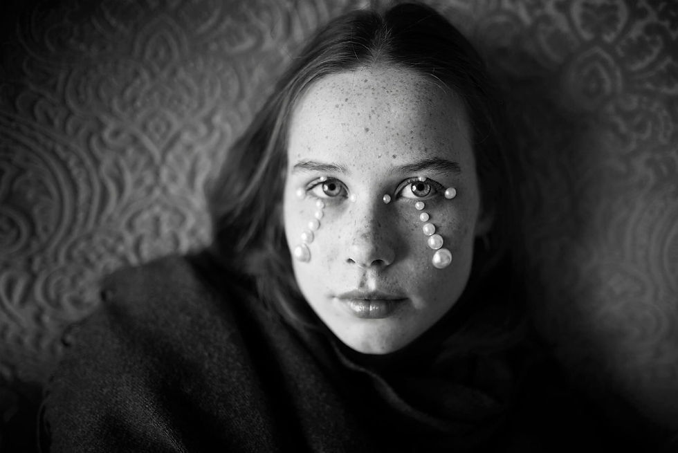 portrait of a teenager with stick on pearl jewelry