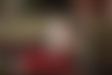 mum holding her new baby on a bench in a stone courtyard in Blackrock