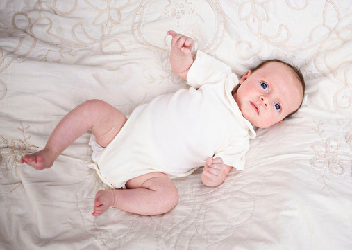 newborn baby portrait, lying on a blanket in park